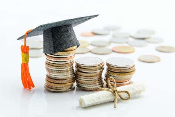 Money cost saving or money reserve for goal and success in school, higher level education concept : US dollar coins / cash, a black graduation cap or hat, a certificate / diploma on white background. tennessee-promise