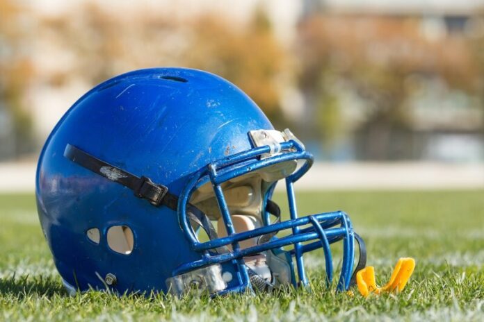 Football helmet on the grass field