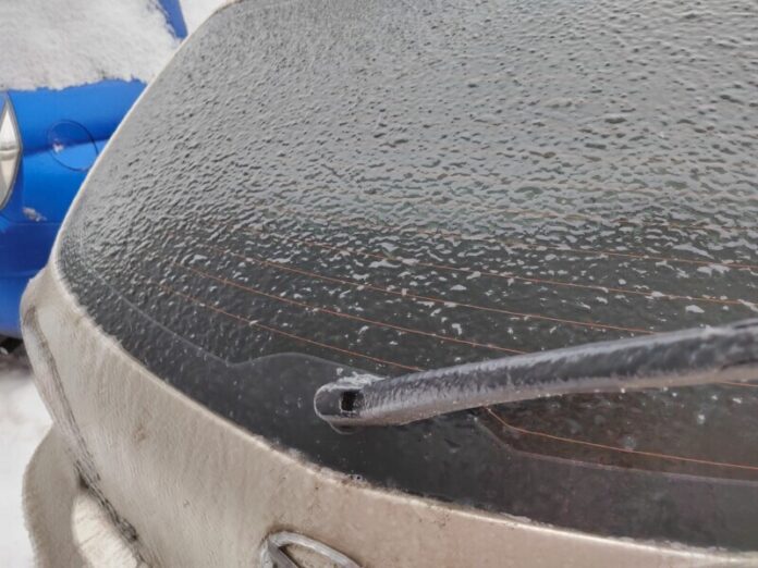 Frozen car. Car on the street covered by icy rain. freezing rain ice coated car.