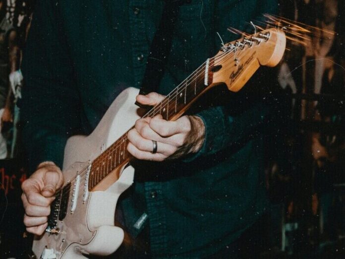 guitar-parker-coffman-GgsG8aNLgjQ-unsplash-e1713214478923