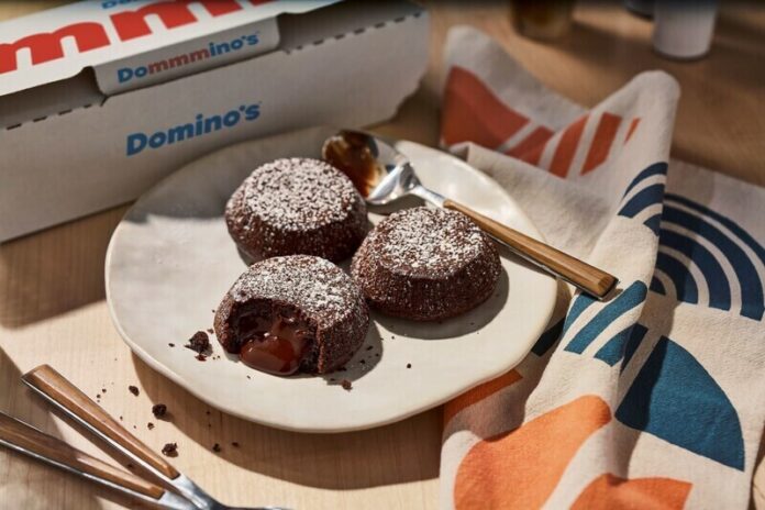 Dominos Chocolate Lava Crunch Cakes In celebration of Domino's 65th birthday, the brand is offering customers a special deal: free Chocolate Lava Crunch Cakes with any online order of at least $10 between Dec. 8-22.