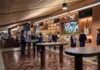 New Nissan Stadium to Feature 22,000-Square-Foot INFINITI Club Multiple people sitting and standing around cocktails tables and lounge couches.
